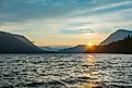 Sunset at Lake Wenatchee State Park, Washington, with the sky glowing in warm hues over the calm lake and surrounding mountains.